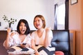 Cheerful couple asian women watching TV feeling having fun .together at home Royalty Free Stock Photo