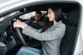 Cheerful couple buying new car in showroom Royalty Free Stock Photo