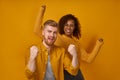 Cheerful couple clenching fists like winners or happy to achieve goal Royalty Free Stock Photo