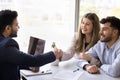 Cheerful couple of clients shaking hands with Indian lawyer man Royalty Free Stock Photo