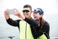 Cheerful couple cyclists making selfie photo