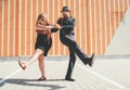 Cheerful couple dancing a retro swing dance to jazz music which was very popular during West Coast Swing era in 1920-40s. They are