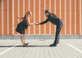 Cheerful couple dancing a retro swing dance to jazz music which was very popular during West Coast Swing era in 1920-40s. They are