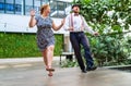 Cheerful couple dressed in vintage clothes dancing retro swing dance to jazz music which was very popular during West Coast Swing