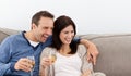 Cheerful couple drinking champagne on the sofa Royalty Free Stock Photo