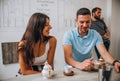 Cheerful couple drinking wine in cafe and having conversation Royalty Free Stock Photo