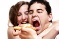 The cheerful couple eating a pizza