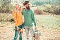 Cheerful couple of farmers standing in vegetable garden. Young Couple gardening in the garden. Portrait of pair of farms