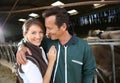 Cheerful couple of farmes feeling happy in barn