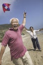 Cheerful Couple Flying Kite On Beach Royalty Free Stock Photo