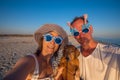 Cheerful couple, in funny sunglasses, with a small dog Royalty Free Stock Photo