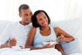 Cheerful couple having breakfast on their bed Royalty Free Stock Photo