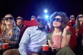 Cheerful couple having date in cinema. Royalty Free Stock Photo