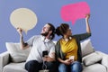 Cheerful couple holding speech bubble icons Royalty Free Stock Photo