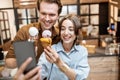 Cheerful couple with ice cream in the shop Royalty Free Stock Photo