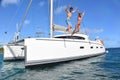 Cheerful couple jumping from sailing boat to the sea