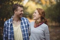 Cheerful couple looking at each other at olive farm