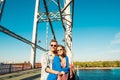 Cheerful couple in love embracing each other on the bridge Royalty Free Stock Photo