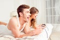 Cheerful couple in love playing video games in bedroom Royalty Free Stock Photo