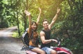 Cheerful couple lover driving off-road and sitting on ATV together,Happy and smiling