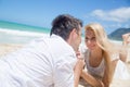 Cheerful couple lying on the beach on a sunny day Royalty Free Stock Photo
