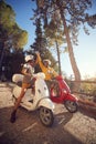 Cheerful couple riding a scooter and having fun on journey Royalty Free Stock Photo