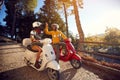 Cheerful couple riding a scooter and having fun Royalty Free Stock Photo