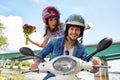 Cheerful couple riding vintage scooter. Royalty Free Stock Photo