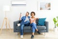 Mixed race couple relaxing under the air conditioner Royalty Free Stock Photo