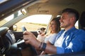 Cheerful couple and their dog traveling by car in summertime Royalty Free Stock Photo