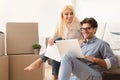 Couple using laptop browsing interior design ideas for new apartment