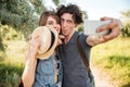 Cheerful couple w hiking in the forest and making selfie Royalty Free Stock Photo