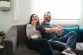 Cheerful couple watching a movie during a leisure day Royalty Free Stock Photo