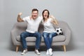 Cheerful couple woman man football fans cheer up support favorite team with soccer ball, hugging, clenching fists