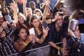 Cheerful crowd photographing performer at nightclub