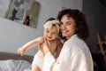 cheerful and curly mother holding in Royalty Free Stock Photo