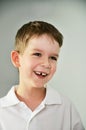 Cheerful cute boy portrait. the boy opened his mouth and lost a Royalty Free Stock Photo