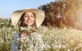 Cute Brown-haired Girl Smelling Field Flowers Royalty Free Stock Photo