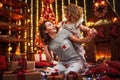 Cheerful cute curly little girl and her older sister exchanging gifts. Royalty Free Stock Photo