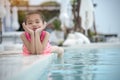 Cheerful cute girl at swimming pool on summer vacation with happiness smiling face. Smile adorable little toddler have fun with Royalty Free Stock Photo