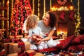 Cheerful cute little girl and her older sister exchanging gifts. Royalty Free Stock Photo