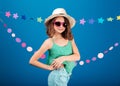 Cheerful cute little girl in sunglasses standing and posing Royalty Free Stock Photo