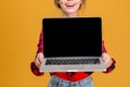 Cheerful cute lovely young woman showing blank screen laptop Royalty Free Stock Photo