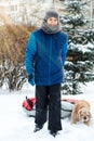 Cheerful cute young boy in blue jacket holds tube on snow, has fun, smiles. Teenager on sledding in winter park. Active lifestyle, Royalty Free Stock Photo