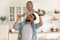 Cheerful dad carrying on neck happy little daughter. Royalty Free Stock Photo