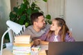 Cheerful daddy helps daughter distance learning