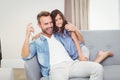 Cheerful daughter and father watching television