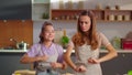 Daughter and mother dancing on kitchen. Family having fun at home in slow motion Royalty Free Stock Photo