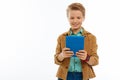 Cheerful delighted boy looking at the tablet screen