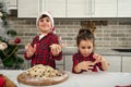 Cheerful delighted children looking at camera and showing their hands in the dough. Adorable kids having fun, playing with dough Royalty Free Stock Photo